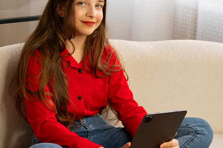 Portrait of smiling teen girl holdin