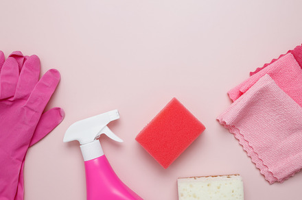 Household cleaning and hygiene concept. Pink cleaning supplies including rubber, a Photo by matucha