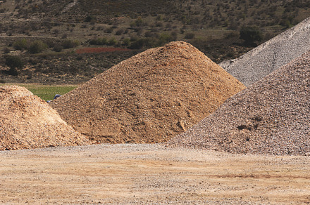 Stacked piles of gravel from a quarr, an Industrial Photo by Perpis