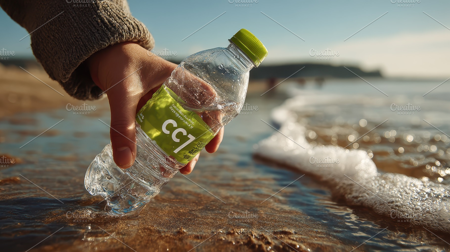 Hand placing water bottle in ocean w, a Photo by Pixeness Studio