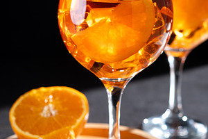 Refreshing Aperol Spritz cocktails with orange slices and ice in elegant glasse, a Food & Drink Photo by etorres69
