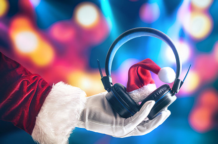 Santa Claus holding headphones on colorful spotlights background, a Sports & Recreation Photo by Davizro's Market