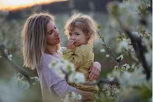Girl with mom in middle of blooming, a Person Photo by HalfPoint