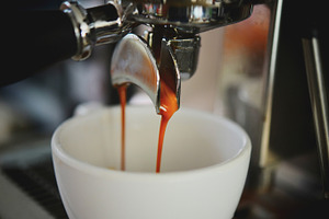 Coffee espresso shot featuring appliance, bar, and barista