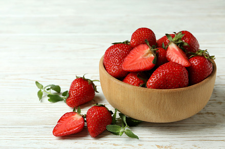 Bowl of strawberry on white wooden background, a Food & Drink Photo by AtlasStudio PRO