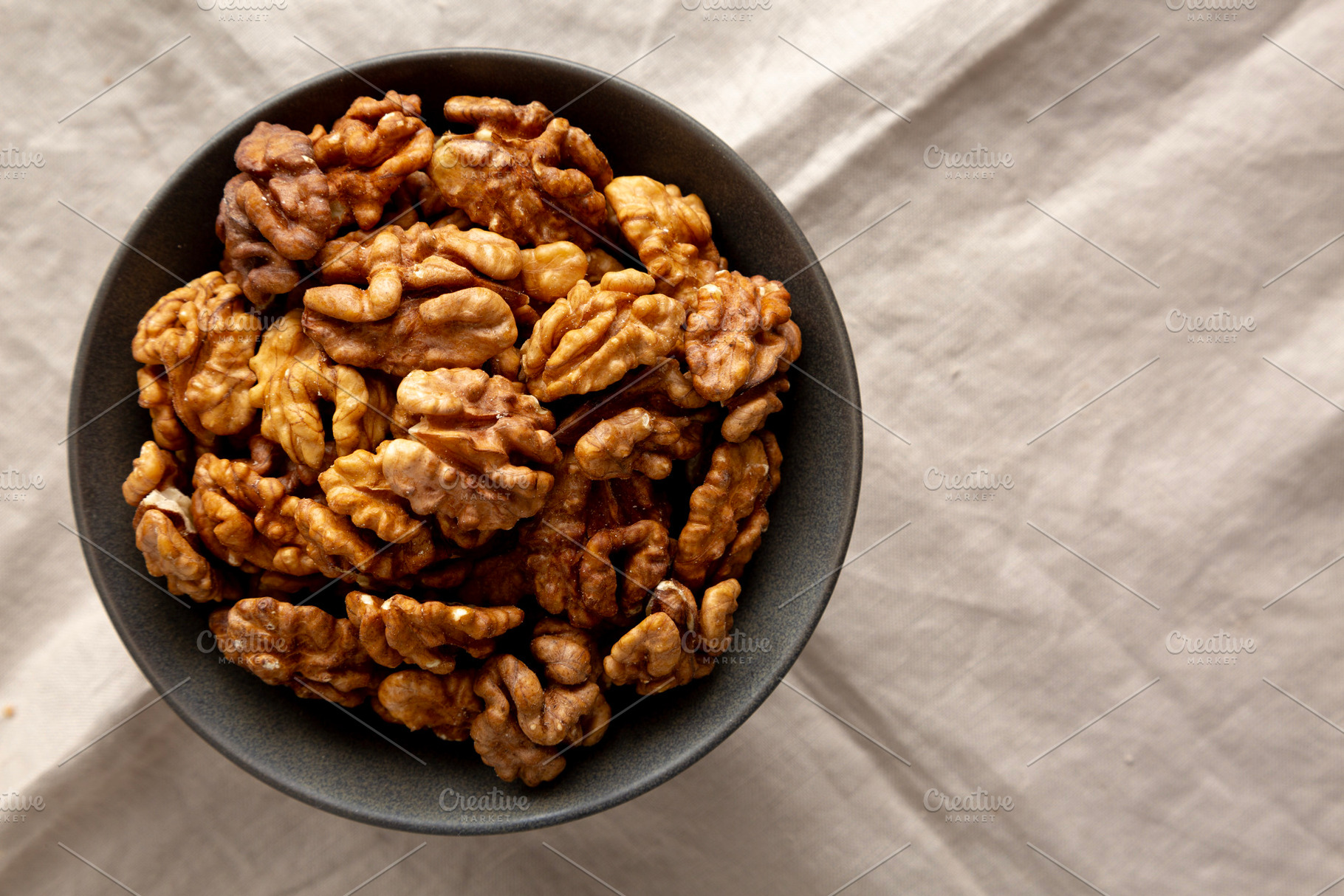 Raw Walnut Halfs in a Bowl, top view. Flat lay, overhead. Copy s, a Food & Drink Photo by LiudmylaChuhunova