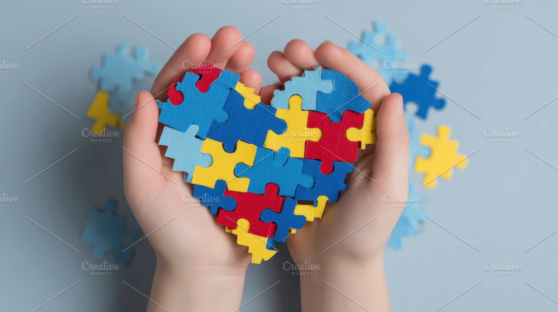Childrens hands holding puzzle heart, a Photo by Pixeness Studio