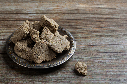 Vegetable-based halva sweet prepared from seeds on wooden background, a Food & Drink Photo by zakiroff