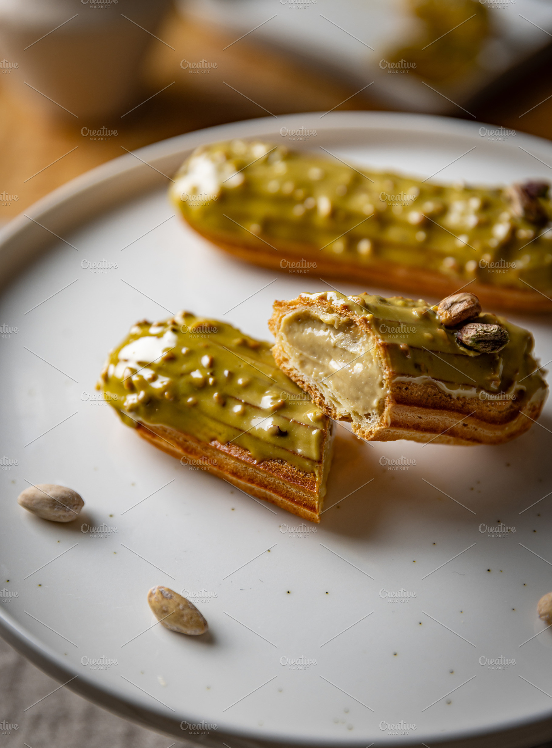 Pistachio eclairs with light green icing, a Photo by Grafvision photography
