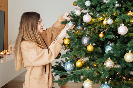 Teenage girl decorates the Christmas tree, a Holiday Photo by Olena Rudo