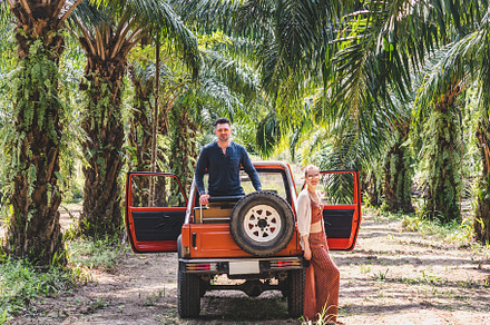 Attractive man, cute woman and a red SUV