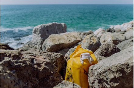 Garbare on stone beach, near the sea, an Industrial Photo by HalfPoint