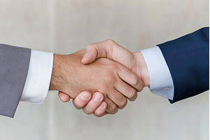 Two men shaking hands in a deal, a Business Photo by Lermont51