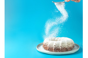 Female hand sprinkling icing sugar, a Food & Drink Photo by Fascinadora