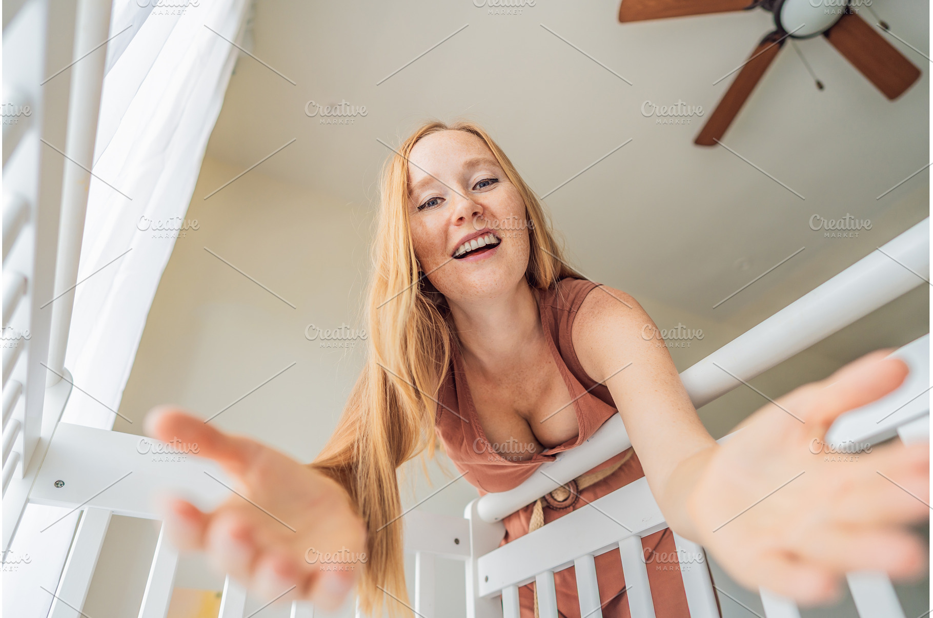 Mother looking into baby crib and, a Person Photo by Elizaveta Galitskaya