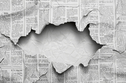 Torn newspaper revealing blank space, a Photo by Tanuart