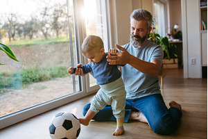 Father playing with little son, a Person Photo by HalfPoint