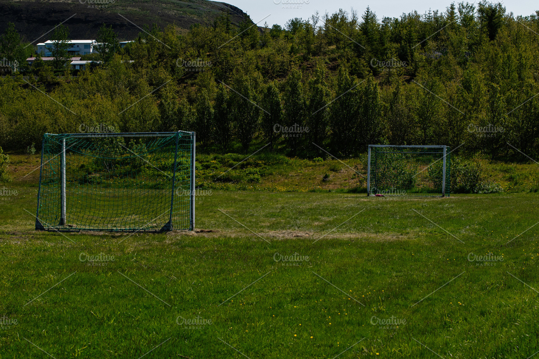 Outdoor soccer goals on a lush field in Mosfellsbær, Iceland, a Photo by AS photostudio