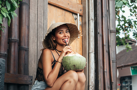 Young woman drinking coconut juice stock photo containing woman and fashion, a Person Photo by Aliaksei Kaponia