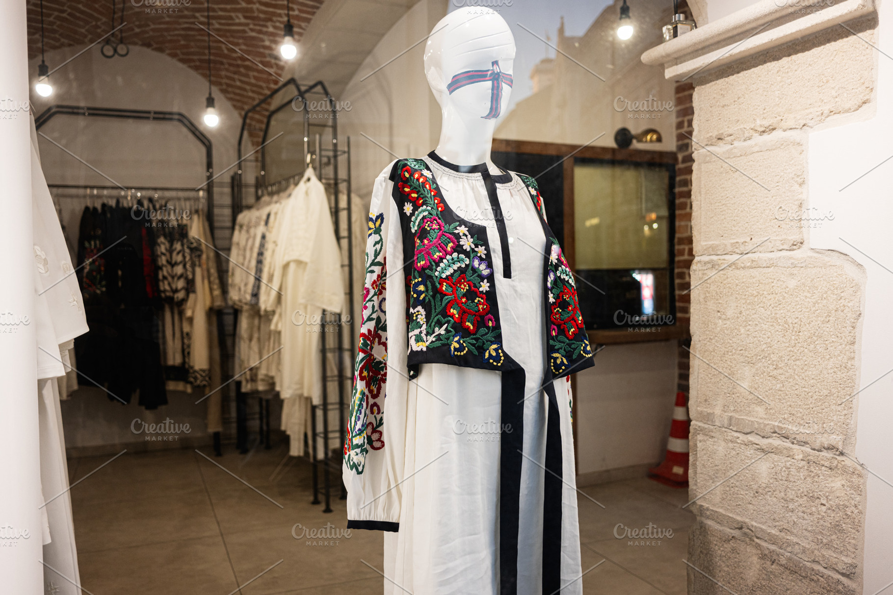 Stylish embroidered ukrainian dress displayed in a boutique with elegant interi, a Photo by AS photostudio