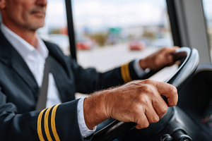 Close-up of a male bus driver, wearing a uniform with captain stripes, focused, a Person Photo by ImageMir