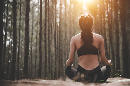 Back view of beautiful woman doing yoga pose in peaceful natural, a Sports & Recreation Photo by Ministocker