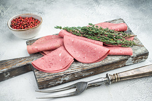 Thin slices of Turkish beef salam on rustic wood with thyme and, a Food & Drink Photo by composter-box@mail.ru