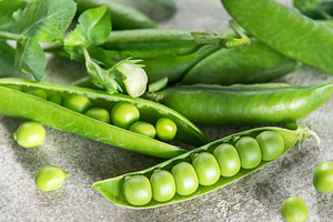 Fresh green peas in pods on stone surface, a Food & Drink Photo by Olena Rudo