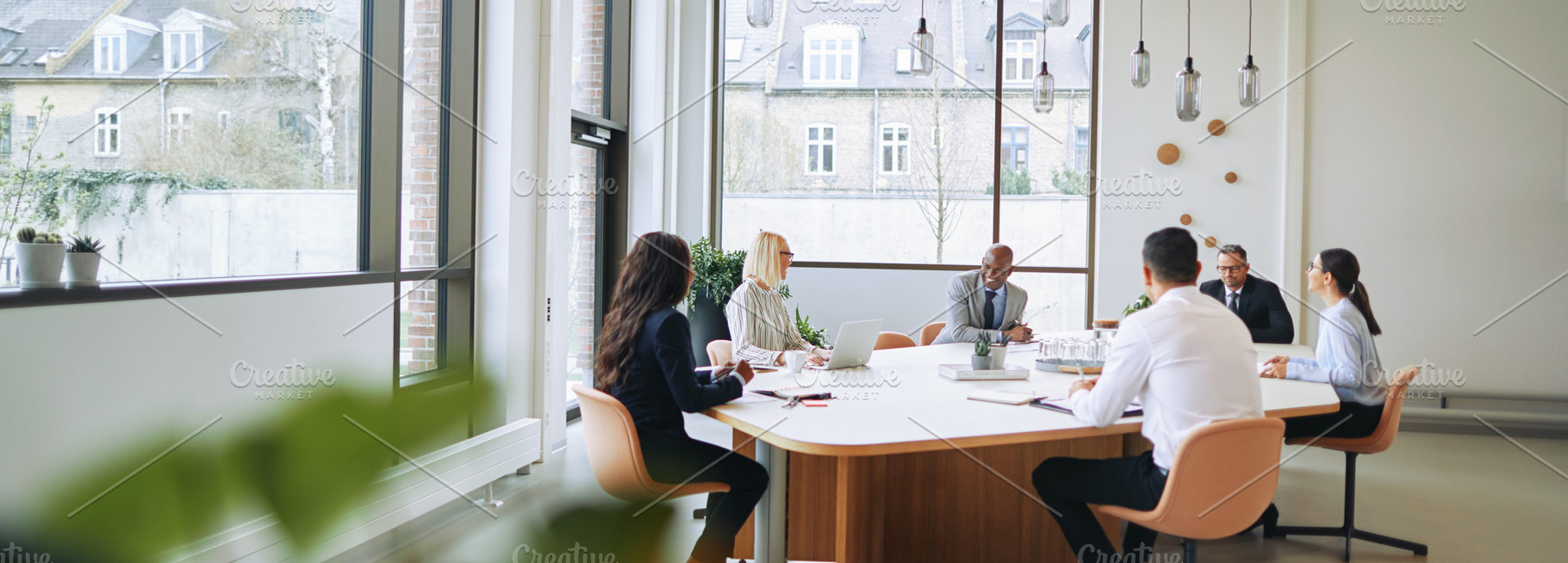 Smiling group of diverse businesspeople having a boardroom meeti, a Business Photo by Stefan & Janni