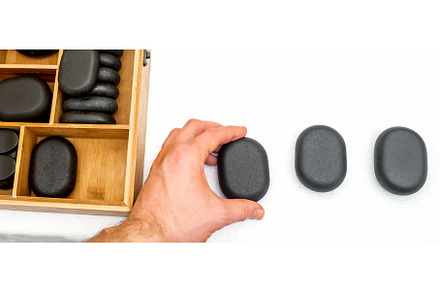 Hot stones for massage in a wooden, a Health & Medical Photo by okskukuruza
