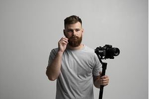 Bearded man holding professional, a Person Photo by volodymyrshtun13795