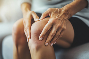Female hands rubbing sore knee, a Health & Medical Photo by MistyDay