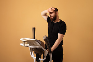 Bearded man in black sportswear looking fatigued while using a s, a Person Photo by Ales Munt
