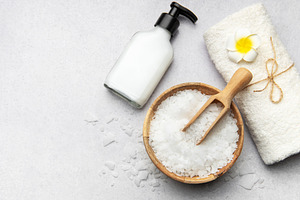 Magnesium flakes in bowl with scoop, towel, and dispenser on gre, a Health & Medical Photo by Olena Rudo