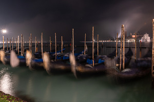 Gondolas along the pavementa and pier of San Marco in Venice, an Architecture Photo by Anna Bogush