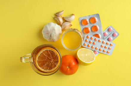 Concept of treatment colds with honey and garlic on yellow backg, a Food & Drink Photo by AtlasStudio