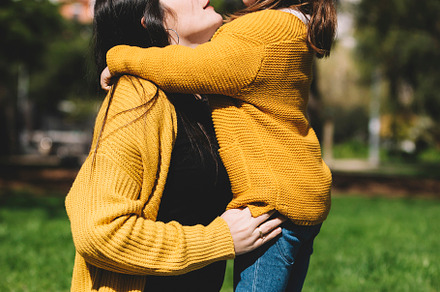 Little cute child baby girl kiss on cheek and hug, embrace with happy pretty wo, a Person Photo by 2Design