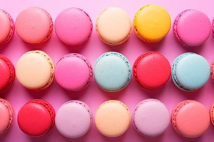Colorful macarons dessert on pink background, a Food & Drink Photo by AlyaAnd