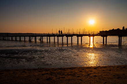The pier at sundown. Wooded bridge seaside with Sunset, Strunjan, a Nature Photo by Bepslabor