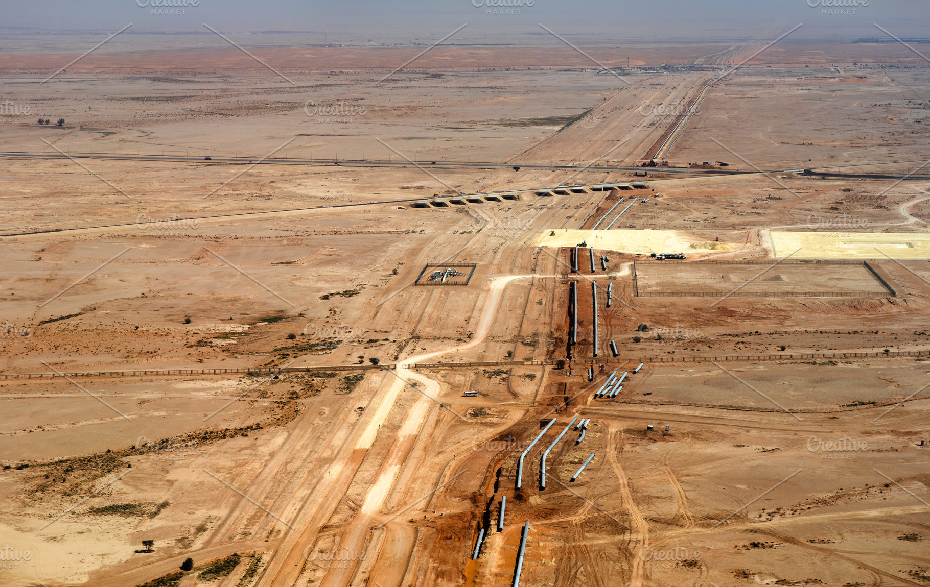 Aerial view of pipeline construction in the desert near Riyadh in Saudi Arabia, an Industrial Photo by Leonid Andronov