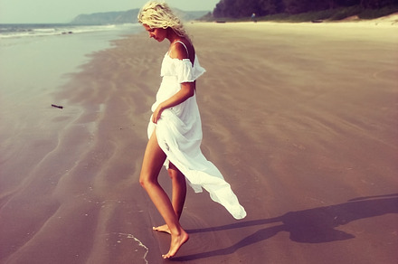 Girl in a white dress by the sea