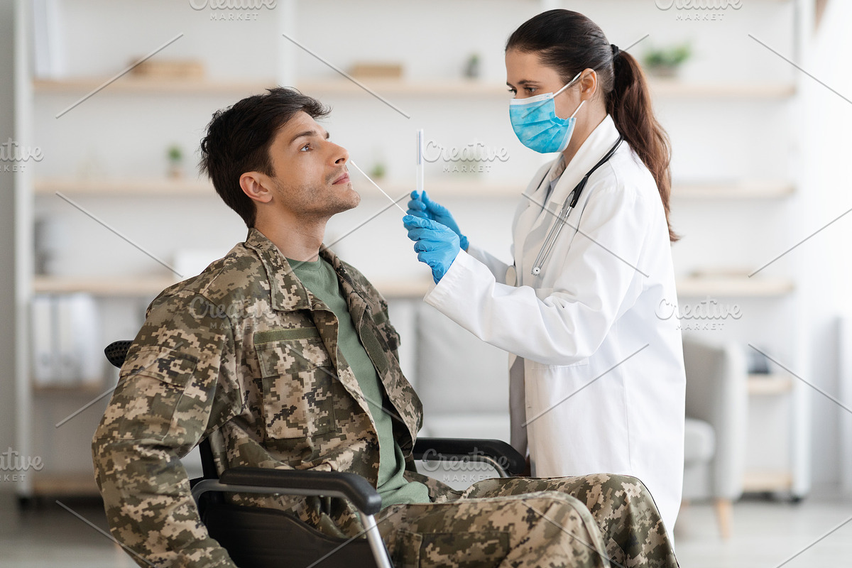 Doctor taking sample for PCR test from disabled soldier, a Photo by Prostock-Studio (Photo 2 of 4)