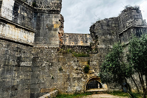 Historic ruins of Tomar Castle showcasing ancient architecture under a cloudy s, a Photo by AS photostudio