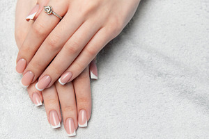 Woman showing french manicure on white towel background, a Beauty & Fashion Photo by Olena Rudo