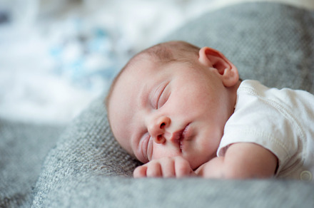 Newborn baby boy lying on bed sleeping close up containing child, baby, and, a Person Photo by HalfPoint