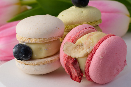 Baked macarons with different flavors on the table, dessert, a Food & Drink Photo by ndanko