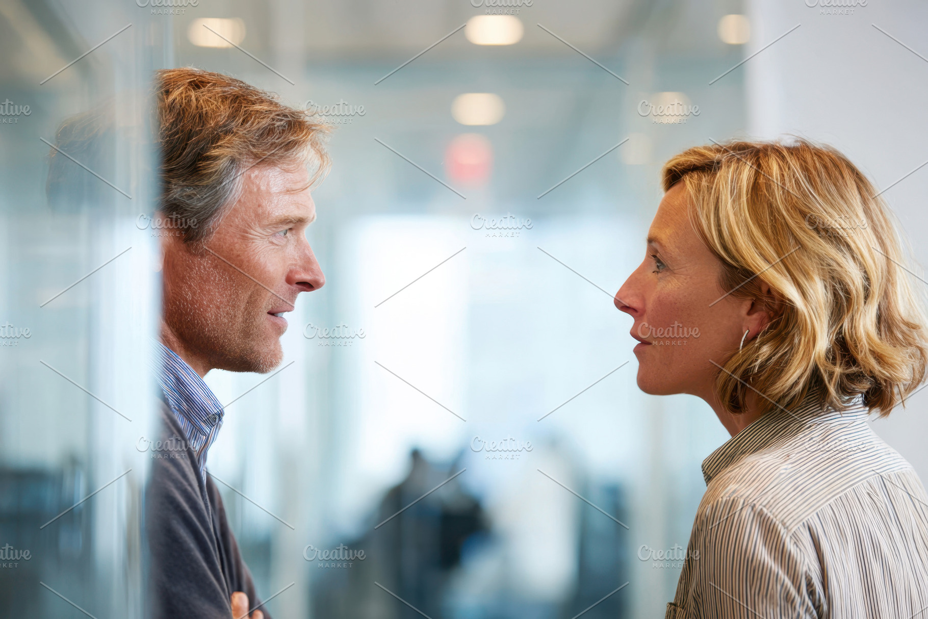 Intense conversation between colleagues in an office, a Business Photo by AlyaAnd