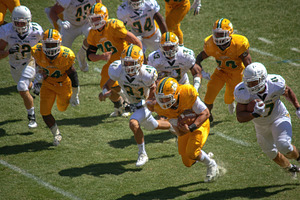 Football player running with the bal, a Photo by Pixeness Studio