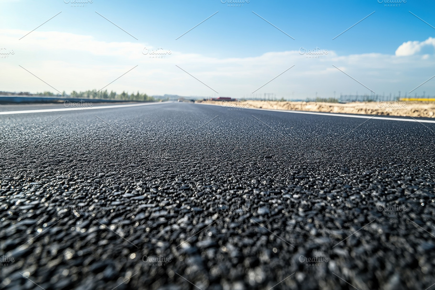 A close-up view of a newly paved asp, a Photo by Tanuart