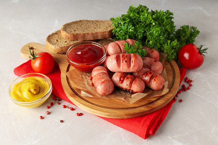 Concept of tasty food, grilled mini sausage, a Background Photo by AtlasStudio PRO